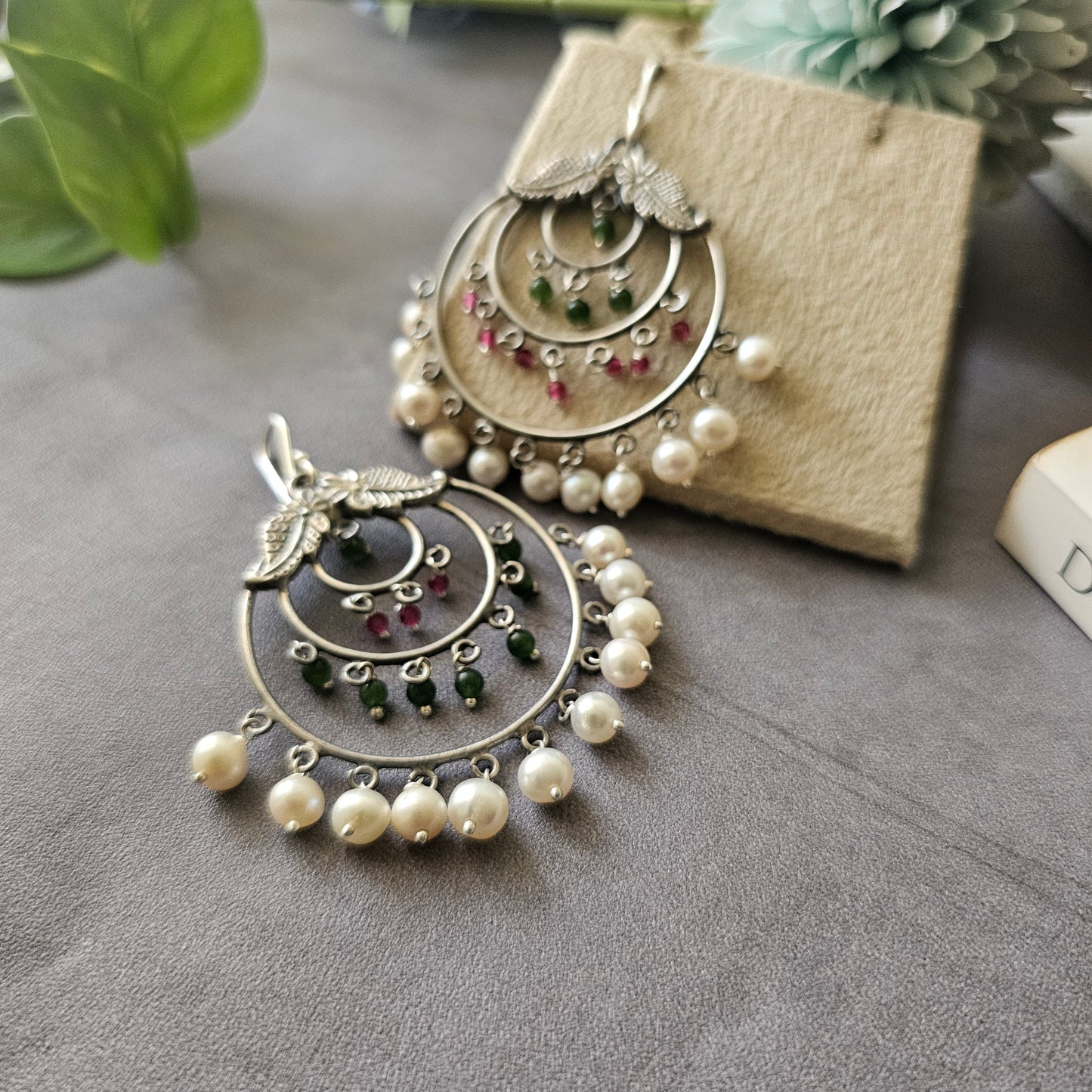 Silver danglers with semiprecious stones and pearl detailing.
