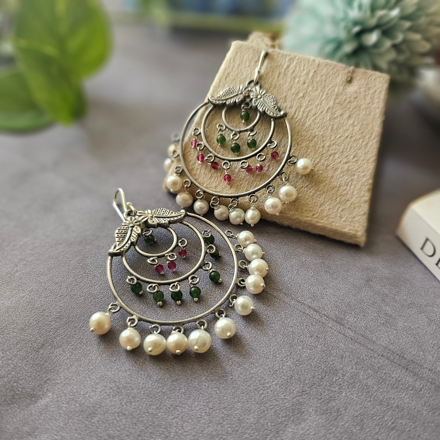 Silver danglers with semiprecious stones and pearl detailing.