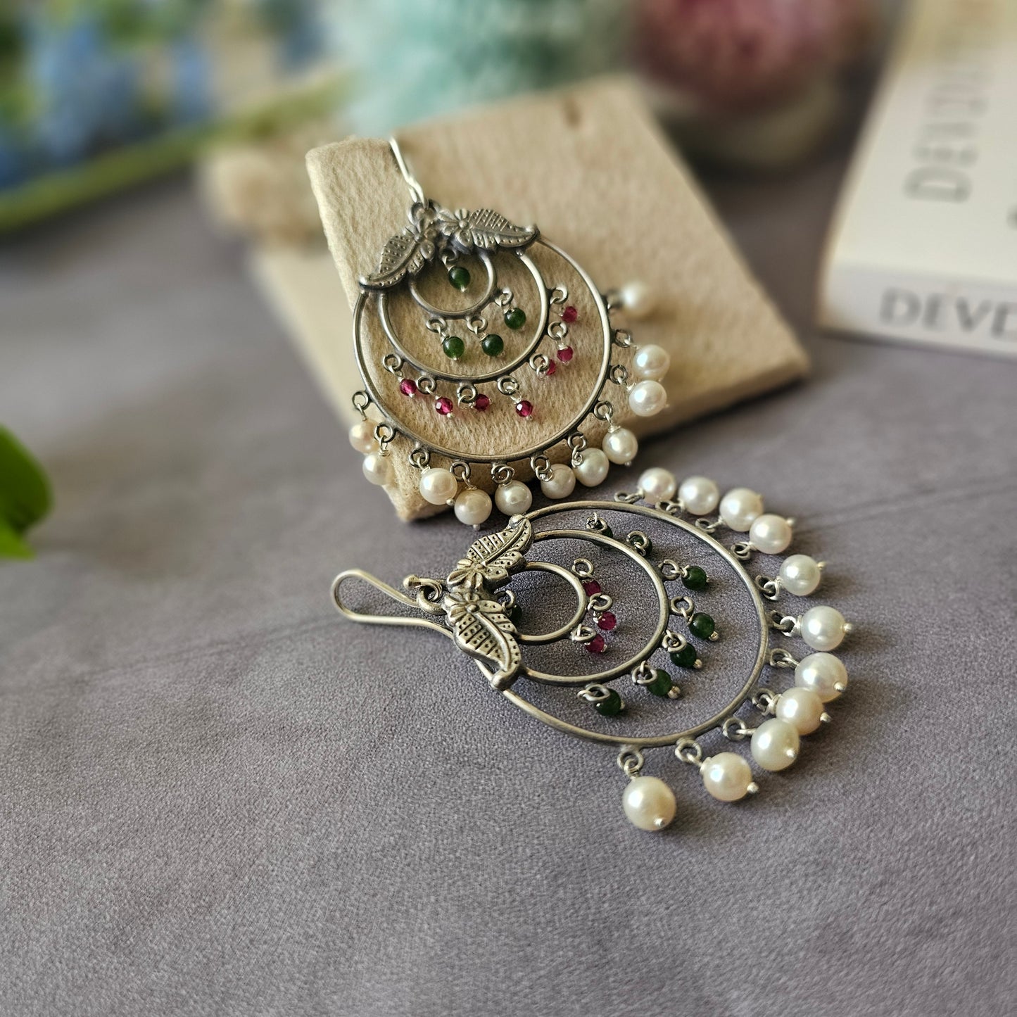 Silver danglers with semiprecious stones and pearl detailing.