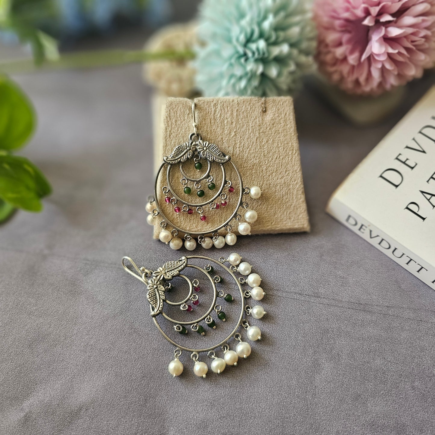 Silver danglers with semiprecious stones and pearl detailing.