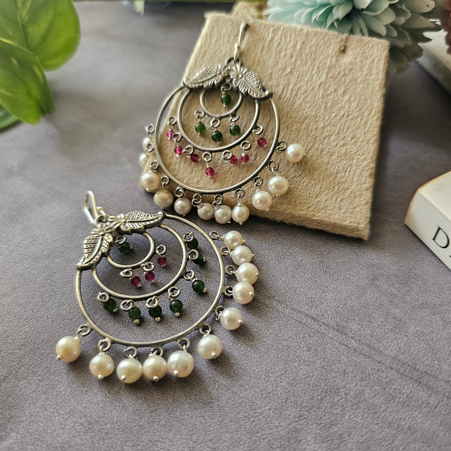 Silver danglers with semiprecious stones and pearl detailing.