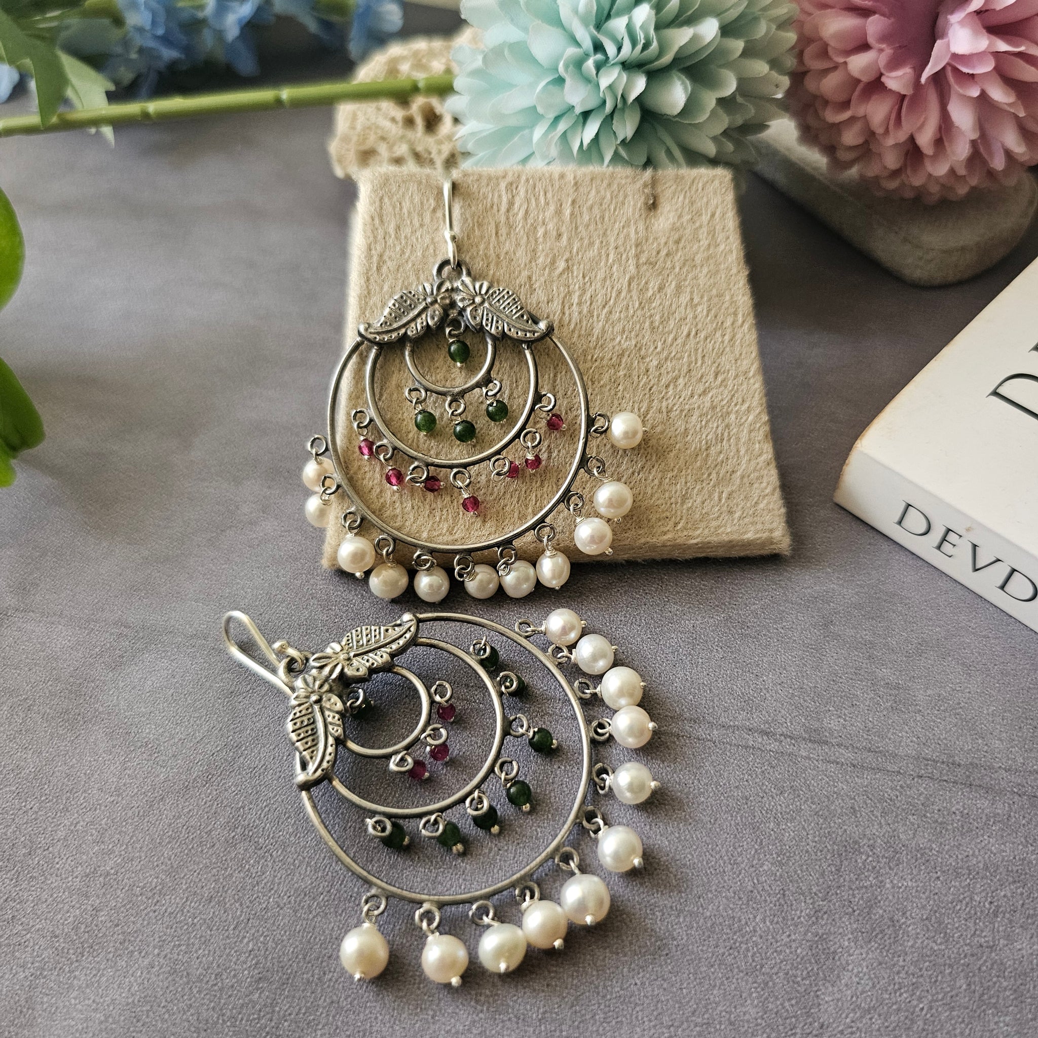 Silver danglers with semiprecious stones and pearl detailing.