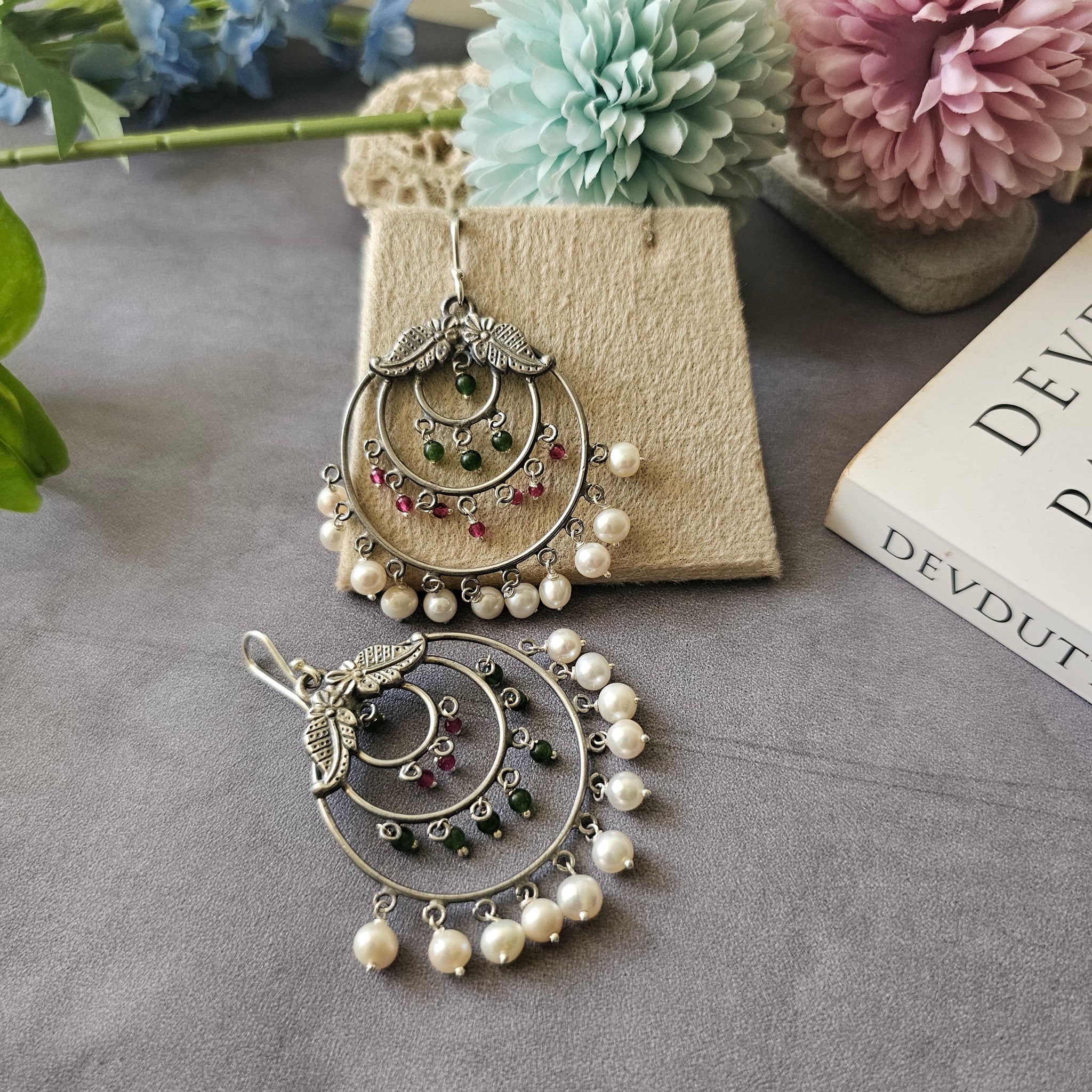 Silver danglers with semiprecious stones and pearl detailing.