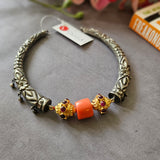 Silver hasli with intricate chithai work, coral, silver nakash beads with kemp